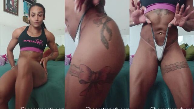 A muscular girl shows off her strength and seduces with her body