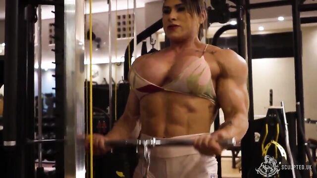 A sexy female bodybuilder dominates her partner with muscle and femdom