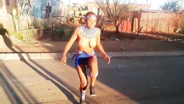 A girl was doing zulu dance with her tits out in public