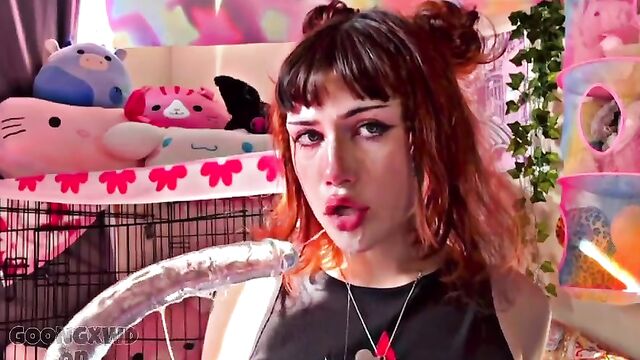 A goth girl masturbates with a big dildo until she comes