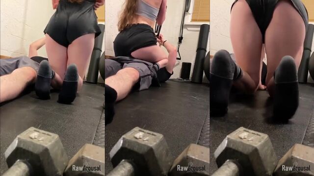 The wife is taking iron from the personal trainer at the gym