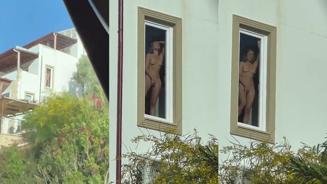 A beautiful girl masturbating in the window of her room for passers-by