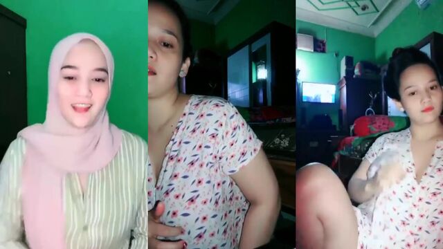 A sexy Indonesian girl with a hijab plays with her big boobs