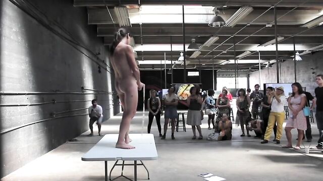 A naked woman has sex on stage and shows her body