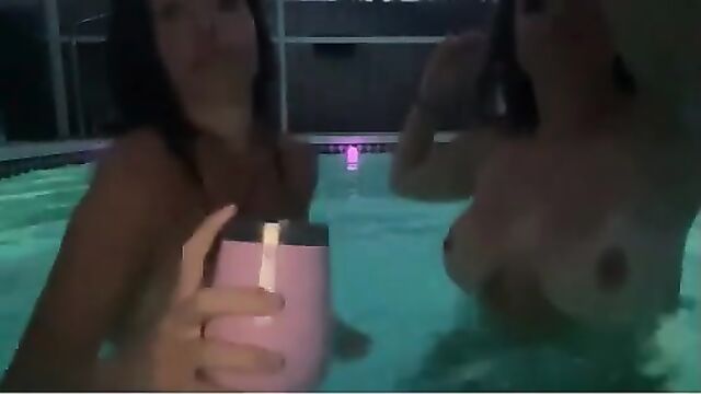 A hot girl is having fun in the pool with someone