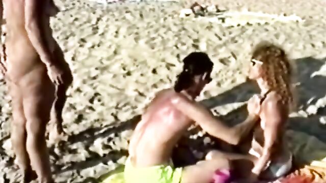 A couple has a great time at the nudist beach, exploring each other
