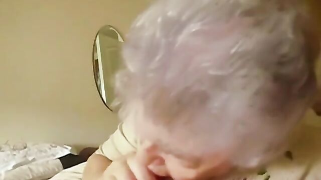A mature woman with silver hair fucks with her young lover