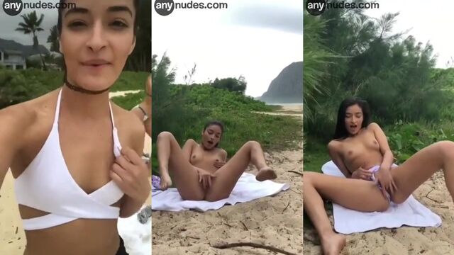 A cute amateur girl plays with her pussy on the beach