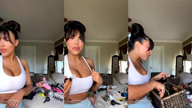 A sexy brunette with big tits takes off her clothes and plays with oil