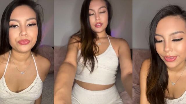 A cute petite Asian girl shows her body in a teasing way