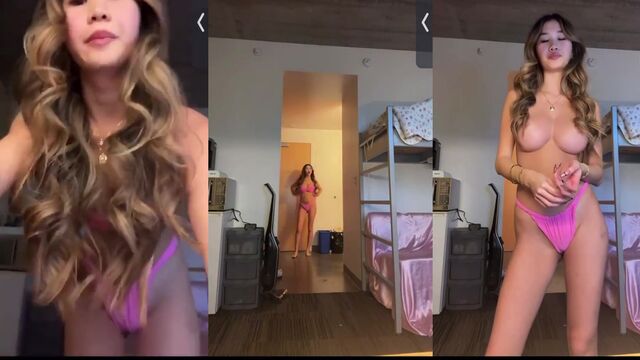 Asian baddie shows off her big tits while posing in red outfit