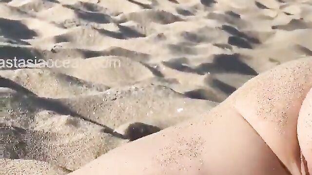 Girl spreads her legs on the sand and has sex