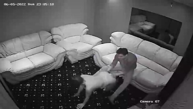 A girl is stripping in front of the security camera at the club