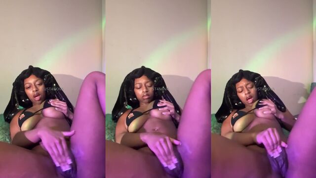 Petite ebony girl plays with an oil and dildo
