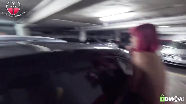 A red-haired slut uses a dildo to catch fish in the garage parking lot